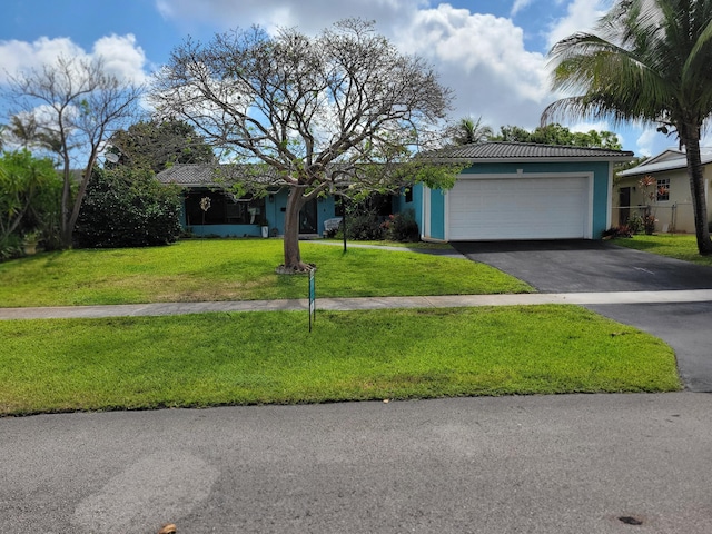 1821 N 50th Ave, Hollywood, FL 33021 - single story home featuring asphalt driveway, an attached garage, a front yard, stucco siding, and a tile roof