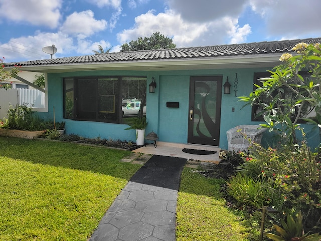 1821 N 50th Ave, Hollywood, FL 33021 - view of front of home featuring a front yard, stucco siding, and a tile roof