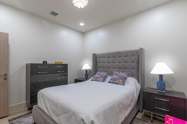 bedroom with recessed lighting, wood finished floors, visible vents, and baseboards