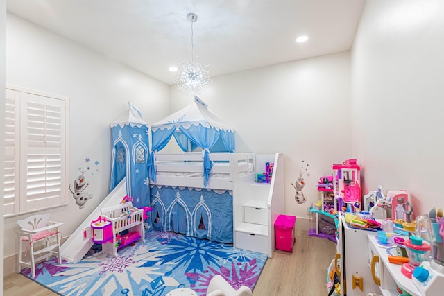 playroom with a chandelier, wood finished floors, and recessed lighting