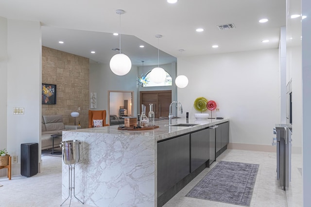 kitchen with visible vents, modern cabinets, light stone counters, a sink, and recessed lighting