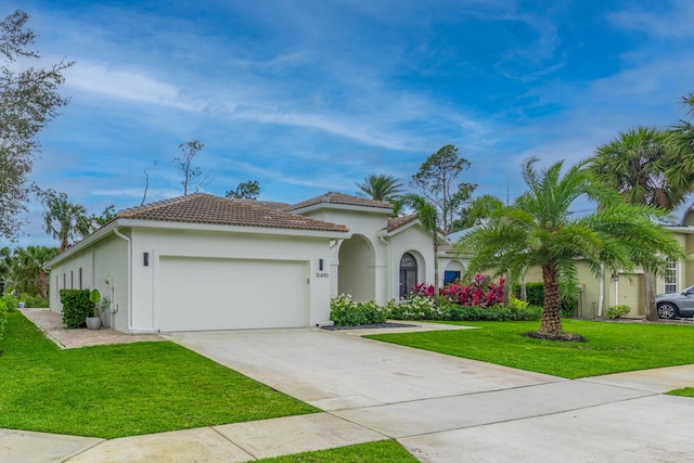 view of front of property featuring stucco siding, concrete driveway, a garage, a tiled roof, and a front lawn