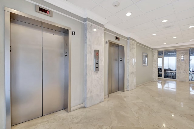 corridor featuring crown molding, elevator, and a paneled ceiling