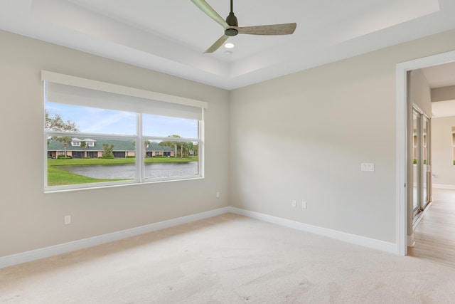 empty room featuring baseboards, a raised ceiling, ceiling fan, carpet flooring, and recessed lighting