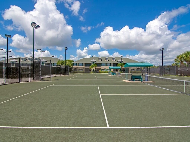 view of sport court featuring fence