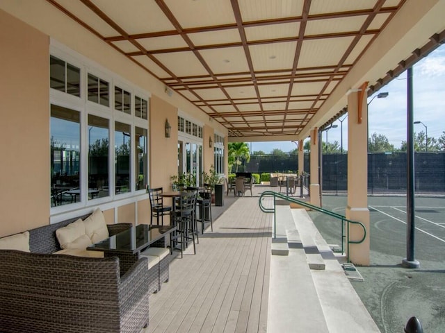 exterior space featuring a swimming pool and coffered ceiling