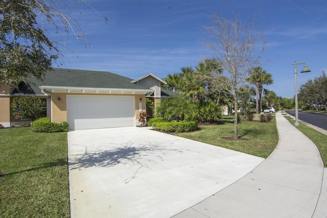 view of front facade with a garage, concrete driveway, a front lawn, and stucco siding