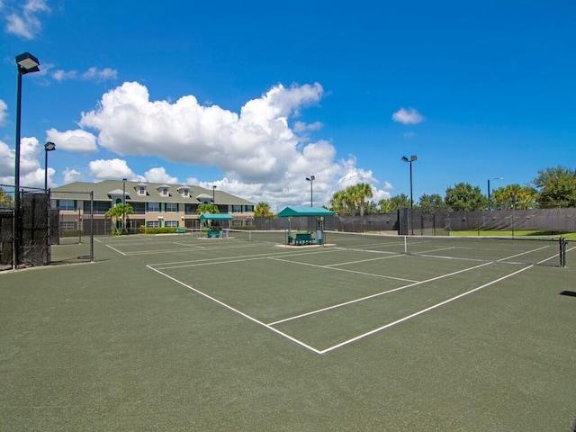 view of sport court featuring fence