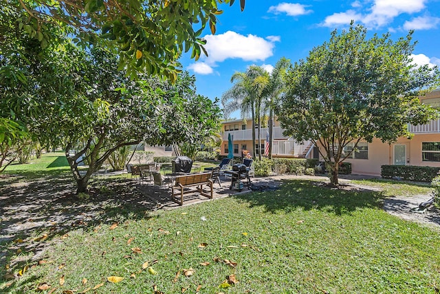 view of community featuring a patio and a lawn