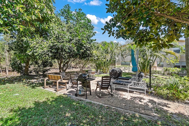 view of yard featuring a patio and a fire pit