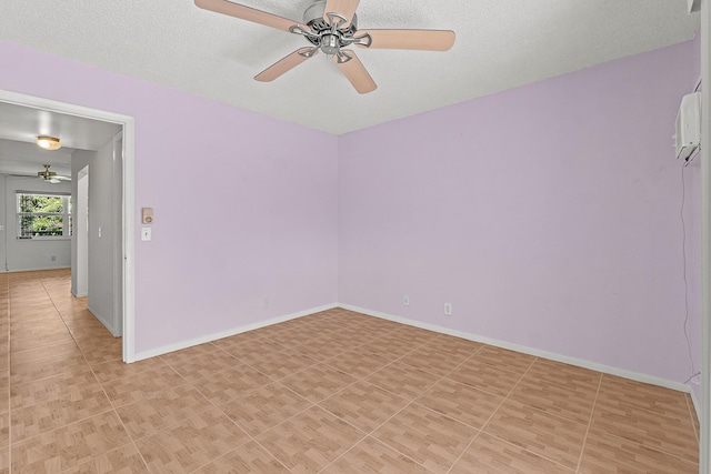 empty room with light tile patterned floors, a ceiling fan, and baseboards