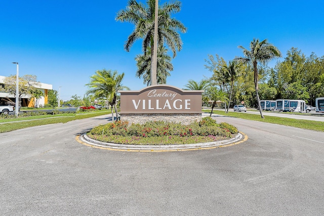 community / neighborhood sign with curved driveway