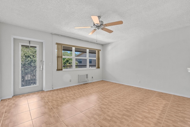 unfurnished room with baseboards, an AC wall unit, tile patterned floors, a textured ceiling, and a ceiling fan