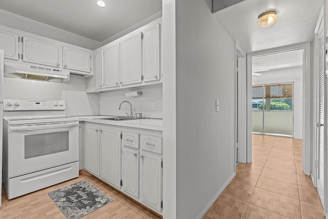 kitchen with white electric range oven, a sink, light countertops, white cabinets, and under cabinet range hood