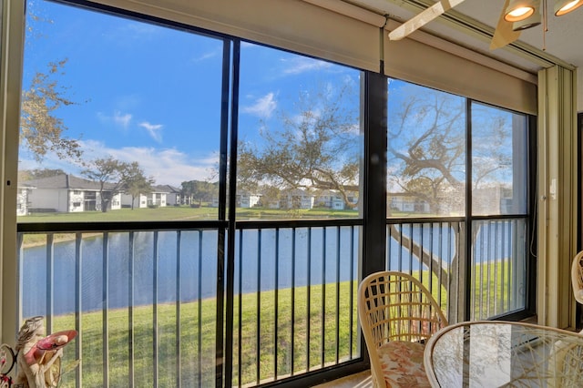 unfurnished sunroom featuring a water view