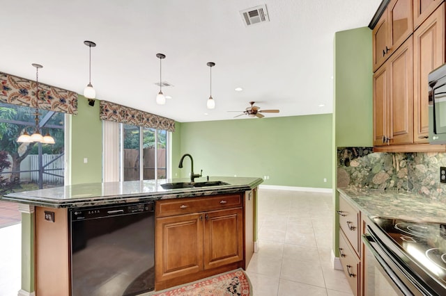 kitchen featuring visible vents, brown cabinetry, dishwasher, hanging light fixtures, and a sink