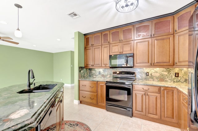 kitchen with range with electric cooktop, a sink, visible vents, hanging light fixtures, and brown cabinetry