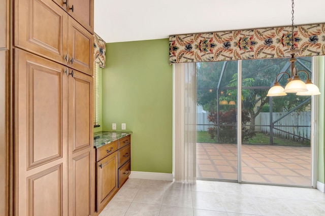 interior space featuring baseboards and light tile patterned floors