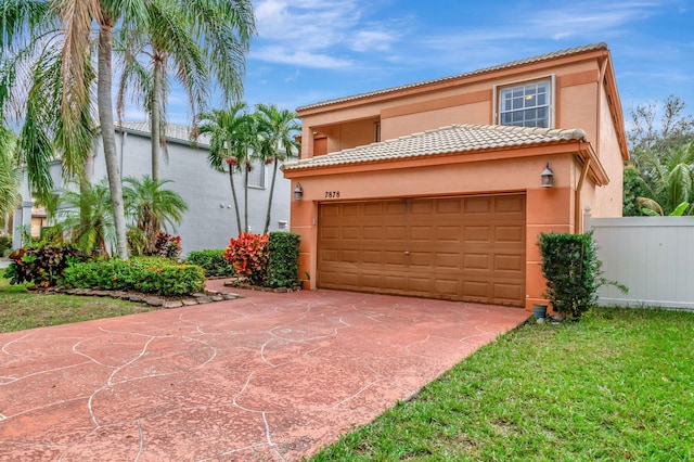 mediterranean / spanish house with concrete driveway, a tile roof, fence, and stucco siding