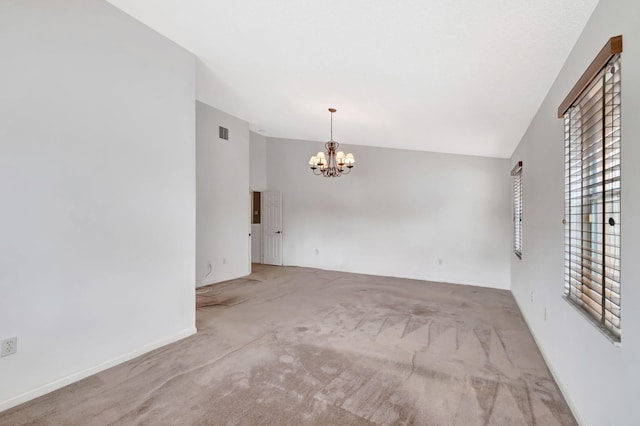 unfurnished room featuring visible vents, light colored carpet, vaulted ceiling, and a notable chandelier