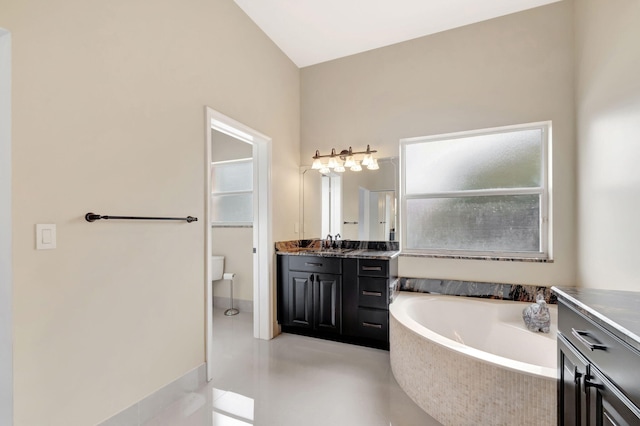 full bathroom with vanity, toilet, and a bath