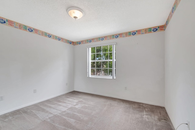 unfurnished room with a textured ceiling, light carpet, and baseboards