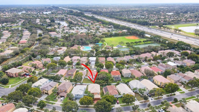 bird's eye view with a residential view and a water view