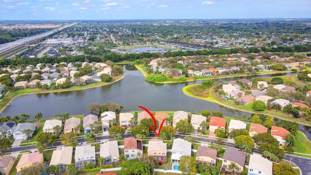 birds eye view of property featuring a residential view and a water view