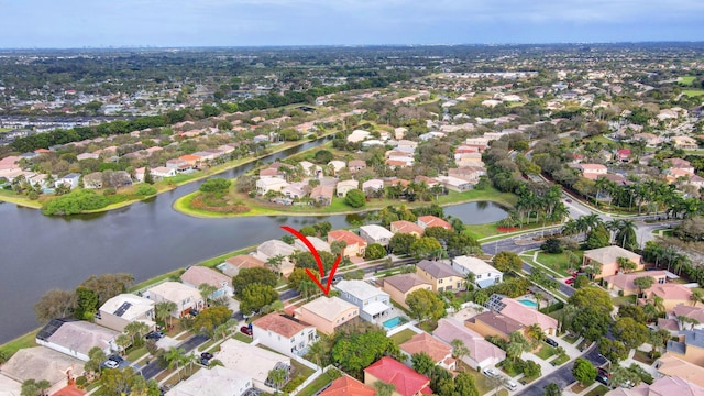 drone / aerial view featuring a residential view and a water view