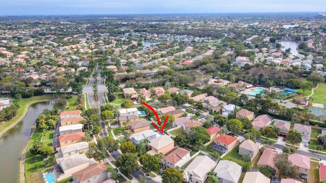 birds eye view of property featuring a water view and a residential view