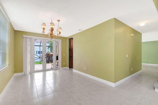 unfurnished room with light tile patterned floors, baseboards, a notable chandelier, and french doors