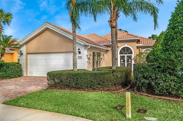 view of front of home with a garage and a front lawn