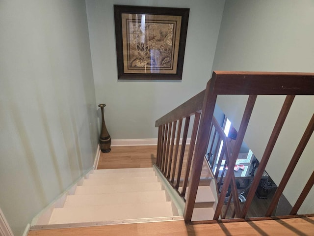 stairway featuring wood-type flooring