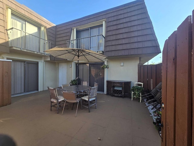 view of patio featuring a balcony