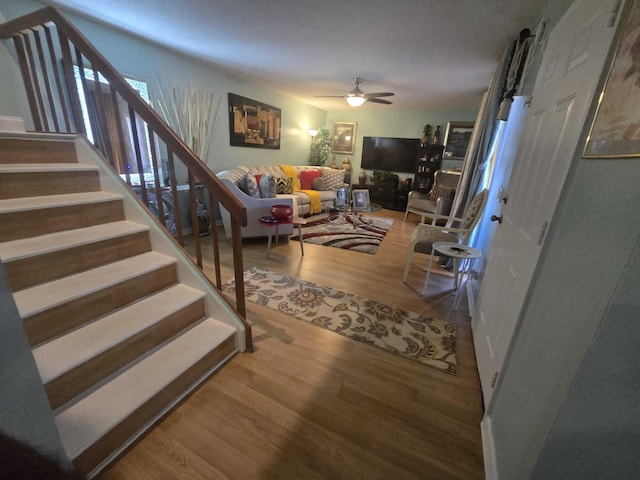 living room featuring hardwood / wood-style flooring and ceiling fan