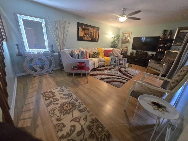 living room with hardwood / wood-style flooring and ceiling fan