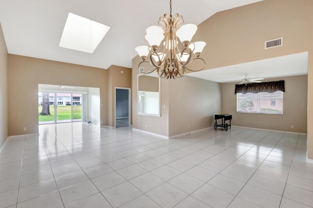 unfurnished room with high vaulted ceiling, a healthy amount of sunlight, light tile patterned floors, and a skylight