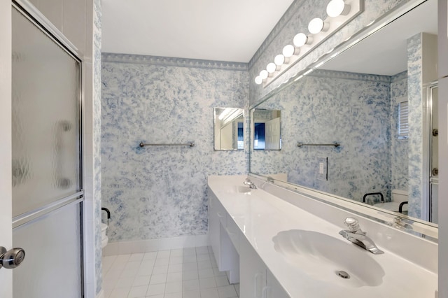 bathroom with tile patterned floors, vanity, and a shower with door