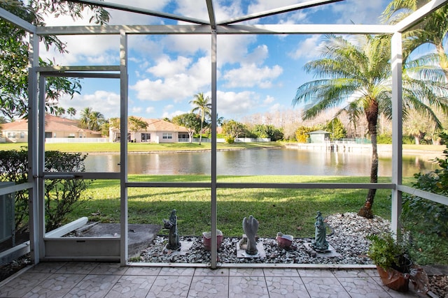 unfurnished sunroom featuring a water view and plenty of natural light