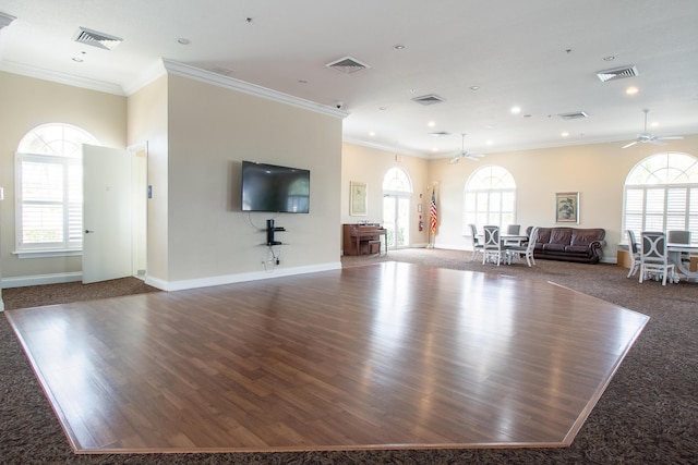 unfurnished living room featuring ornamental molding, wood finished floors, and visible vents