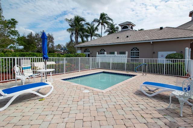 view of pool featuring a patio area and fence