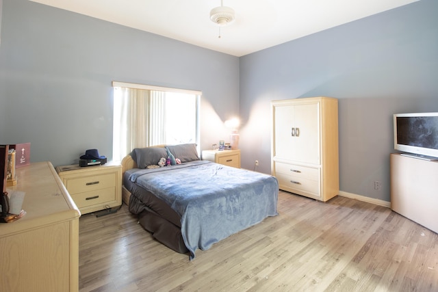 bedroom featuring baseboards and light wood-style floors