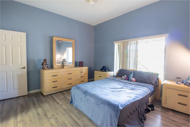 bedroom featuring light wood-style flooring and baseboards