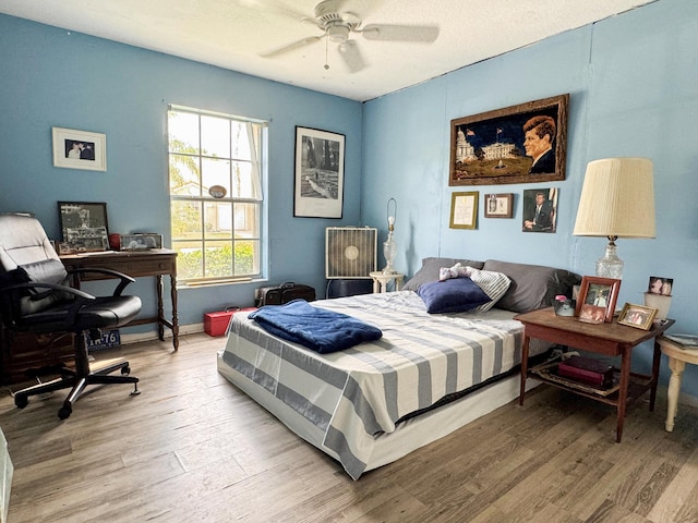 bedroom featuring ceiling fan and light wood finished floors