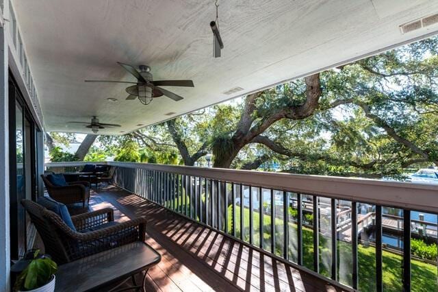 wooden deck featuring ceiling fan