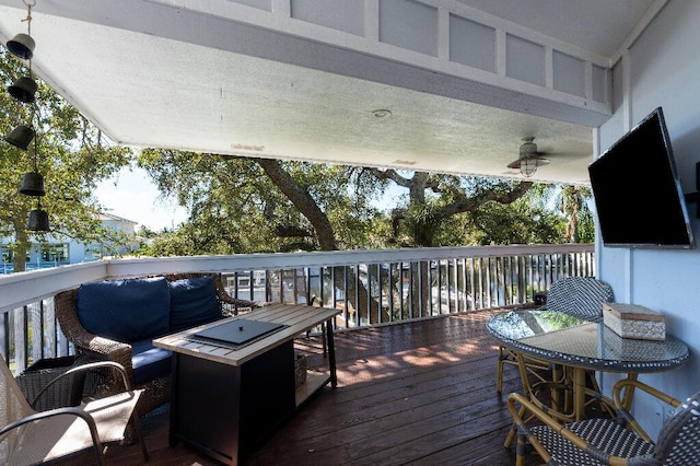 wooden terrace featuring a fire pit and ceiling fan