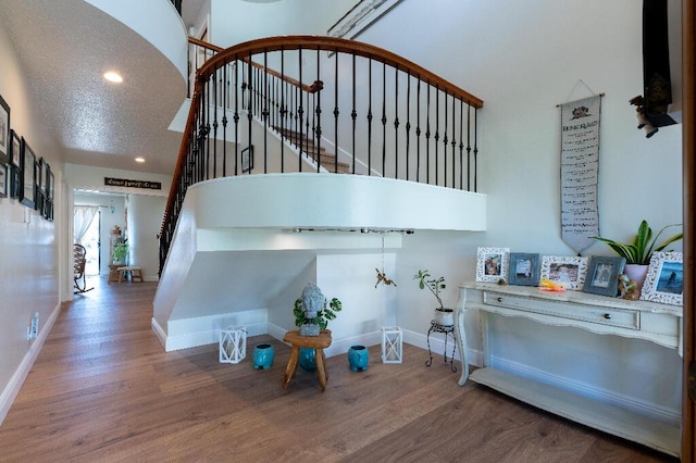 interior space featuring hardwood / wood-style flooring and a textured ceiling