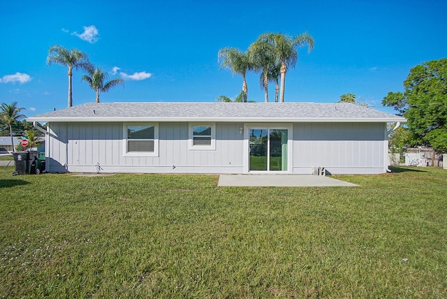 rear view of property featuring a yard and a patio area