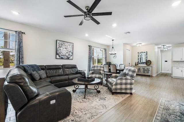 living room featuring light hardwood / wood-style floors and ceiling fan