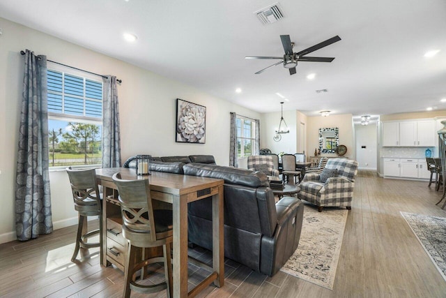 living room with ceiling fan, a healthy amount of sunlight, and light hardwood / wood-style floors